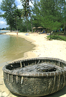 Coracle, woven basket boat, on beach of Phu Quoc Island, Vietnam, by Ron Gluckman